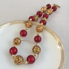 Necklace with speckled colours and red Murano glass sphere beads on gold